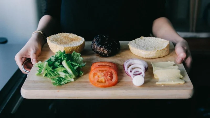 Ingredients for a burger showcasing a balanced diet on a cutting board