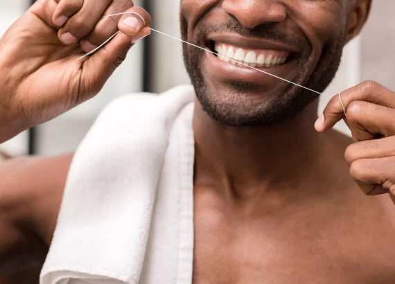 Longevity tips: cropped shot of young man cleaning teeth with dental floss