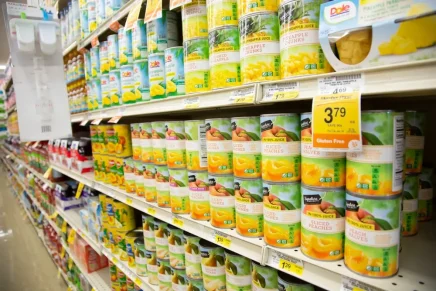 Canned fruit aisle in a supermarket, highlighting the diet myths of life-shortening sneak attack snacks.