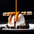 Decadent dessert challenging diet myths, featuring a caramel drizzle over ice cream and brownie.