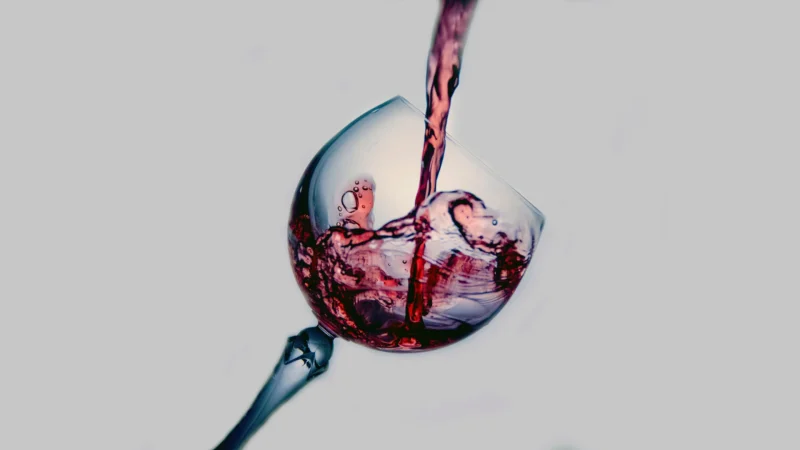 alcohol in white glass pouring