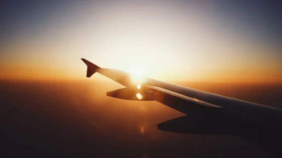 The sun over the wing as seen from inside the airplane, reminder of the jet lag that often follows such flights.