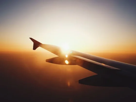 The sun over the wing as seen from inside the airplane, reminder of the jet lag that often follows such flights.