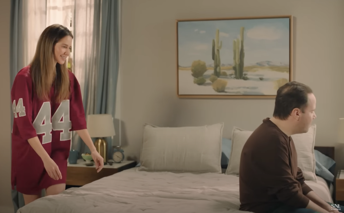 SNL couple wearing generic football jerseys