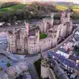 Caernarfon Castle in Gwynedd Wales at dusk