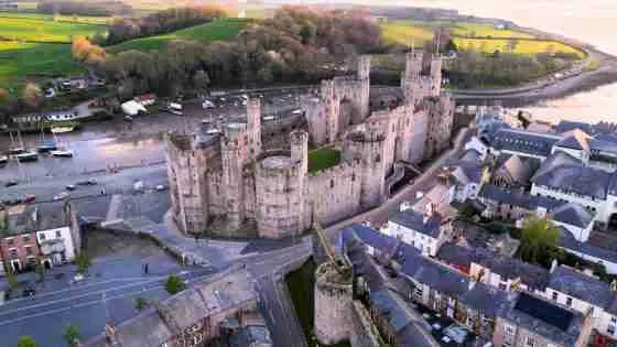 Caernarfon Castle in Gwynedd Wales at dusk